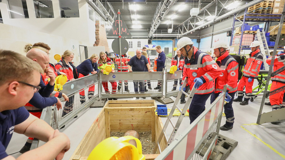 Rettungssanitäter stehen um eine Baugrube